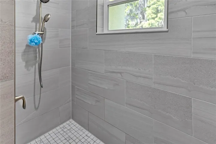 Large spacious shower in the primary bathroom.