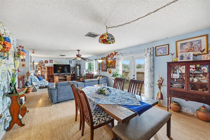 Open floor plan. The kitchen connects seamlessly to the dining and living areas. The french doors lead you to the  deck.