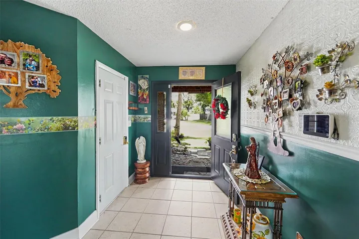 Foyer. The white door on the left take you to the 2-car garage. A staircase leads you to the living area.