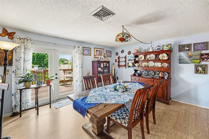 Open floor plan. The kitchen connects seamlessly to the dining and living areas. The french doors lead you to the  deck.
