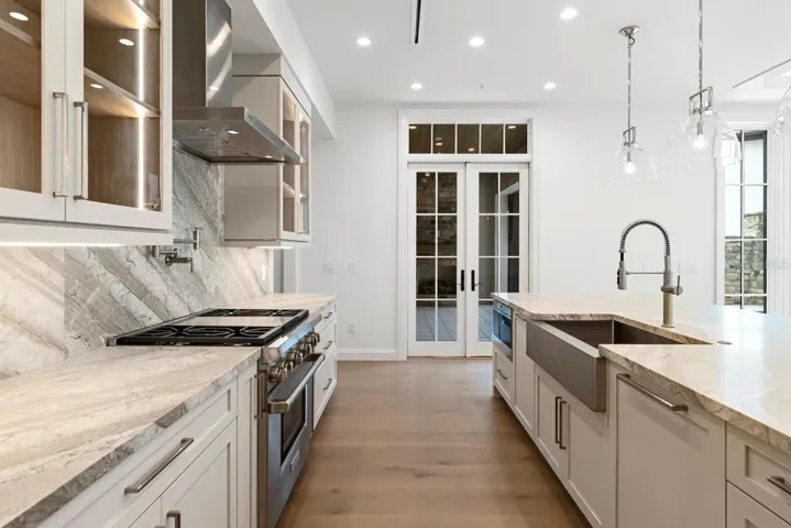 Gourmet kitchen with frameless contemporary cabinetry and alarge prep island