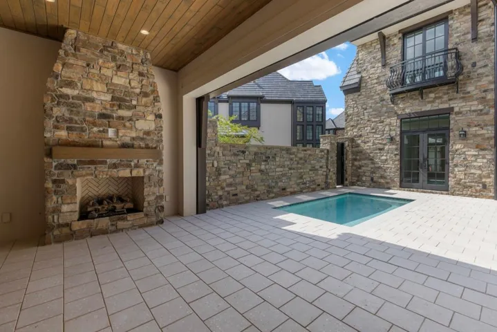 Outdoor living area with summer kitchen and heated lounging pool