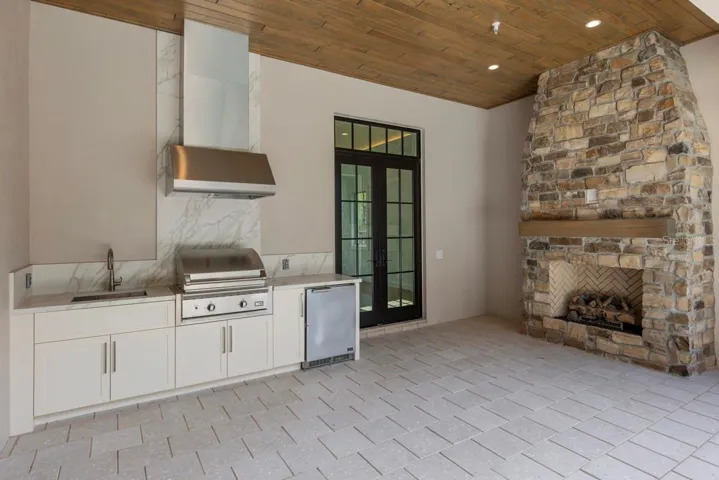 Outdoor living area with summer kitchen and heated lounging pool