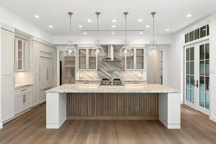 Gourmet kitchen with frameless contemporary cabinetry and alarge prep island