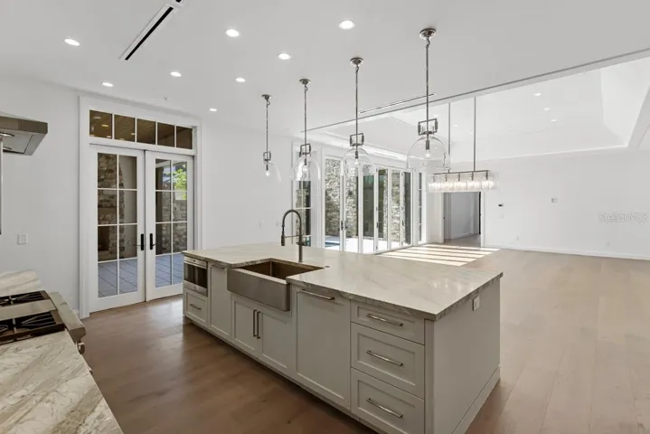 Gourmet kitchen with frameless contemporary cabinetry and alarge prep island