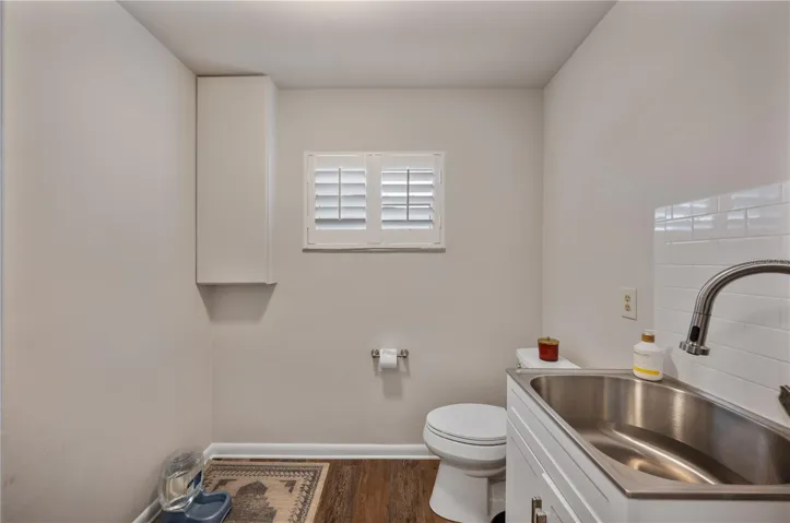 Large half bathroom right off the kitchen features ample space to dog condos as well!