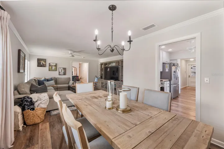 The formal dining room as it flows into the beautifully updated eat in  kitchen.