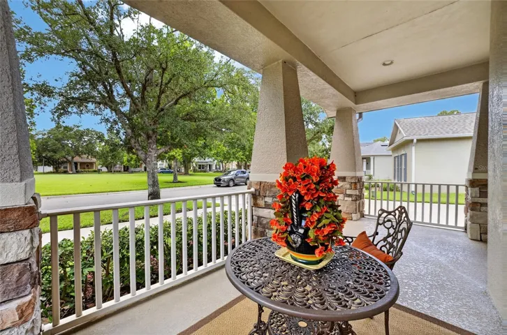 Amazing covered front porch overlooking the greenspace across the street.