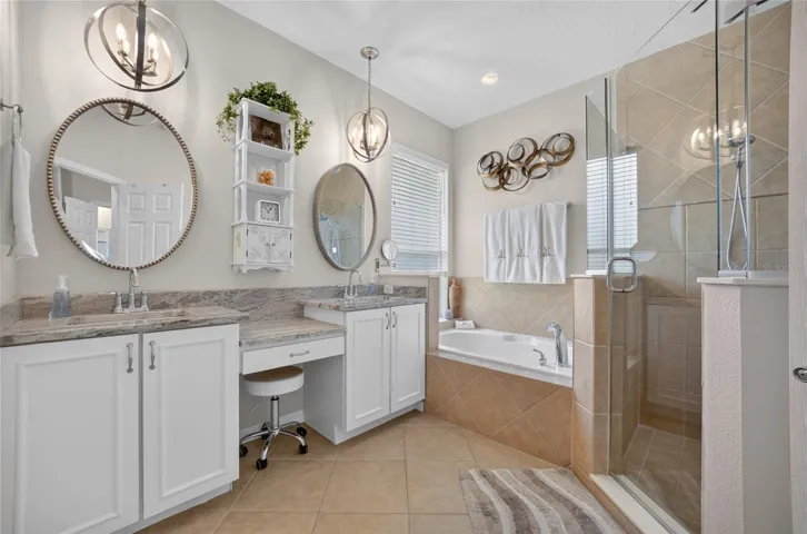 Primary bath with newer granite counters, mirrors, faucets and white vanity