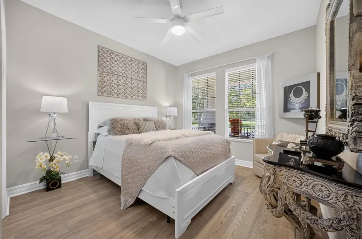 Bedroom 2 with beautiful new laminate 2026, newer ceiling fan and tons of natural light