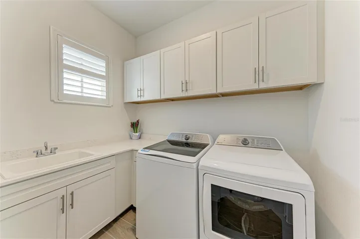 Private Laundry with storage cabinets and plantation Shutter