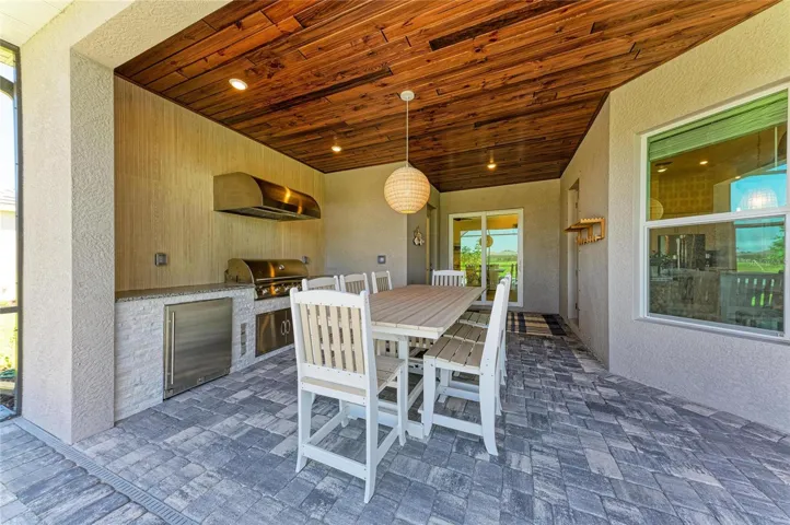 Custom Outdoor Kitchen with Tile Backsplash and Stainless Steel Appliances