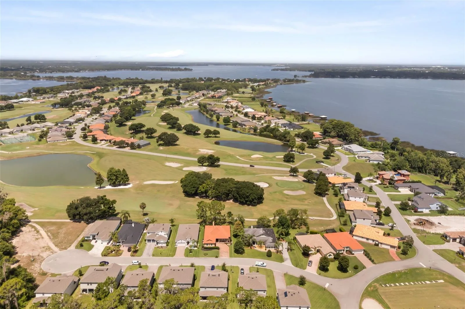 Aerial showing Deer Island: bottom right Driving Range, right Lake Dora, Top left causeway between Lake Dora &amp; Lake Beauclair