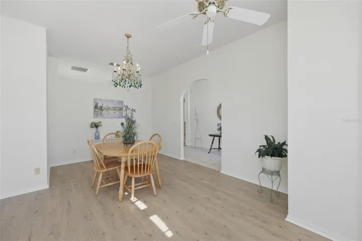 Large Front Room - Use as Dining/Office/Den High Ceilings, Newer LVT Flooring, & Arched Doorway