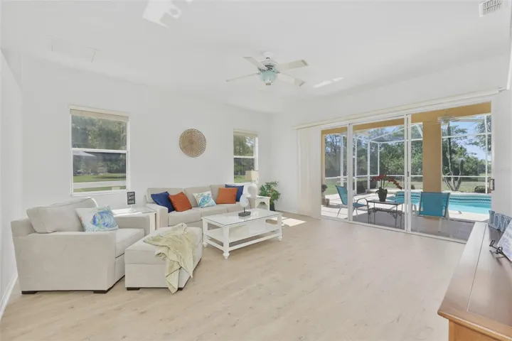 Living Room, Newer LVT Flooring, Sliders to Fabulous Pool & Outdoor Living Space