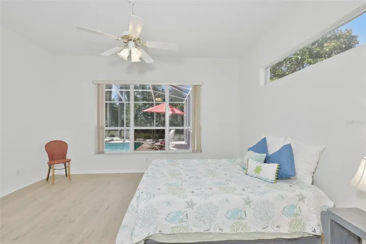 Large Primary Bedroom w/ Ensuite Bath, Newer LVT Flooring, View of the Pool & Wonderful Outdoor Living Space