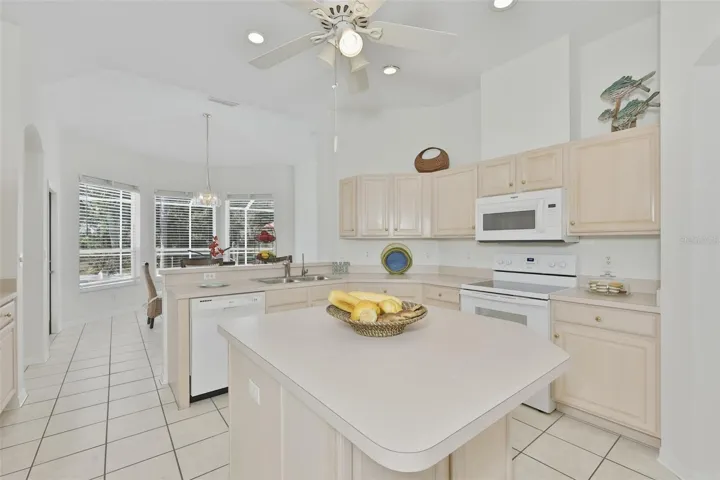 Refaced Cabinets, Tiled Floor, Large Center Island with Storage, Eat In Dinette With Great View of Pool & Rear Greenspace