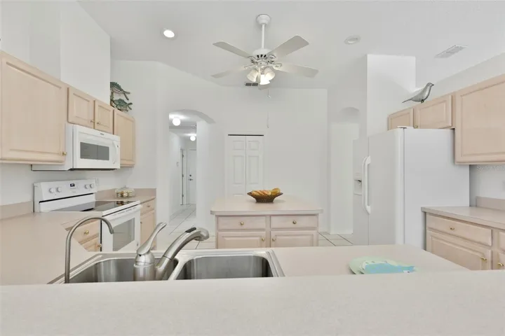 Refaced Cabinets, Tiled Floor, Large Center Island with Storage, Eat In Dinette With Great View of Pool & Rear Greenspace