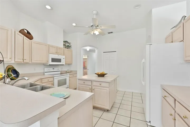 Refaced Cabinets, Tiled Floor, Large Center Island with Storage, Eat In Dinette With Great View of Pool & Rear Greenspace