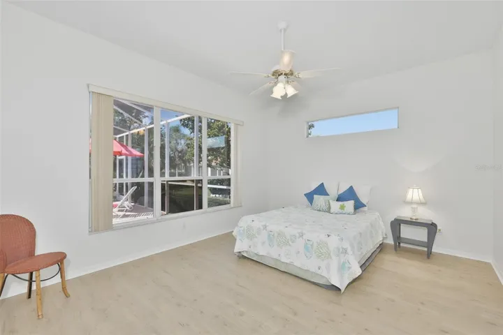 Large Primary Bedroom w/ Ensuite Bath, Plenty of Light, Newer LVT Flooring & View of the Pool & Wonderful Outdoor Living Space