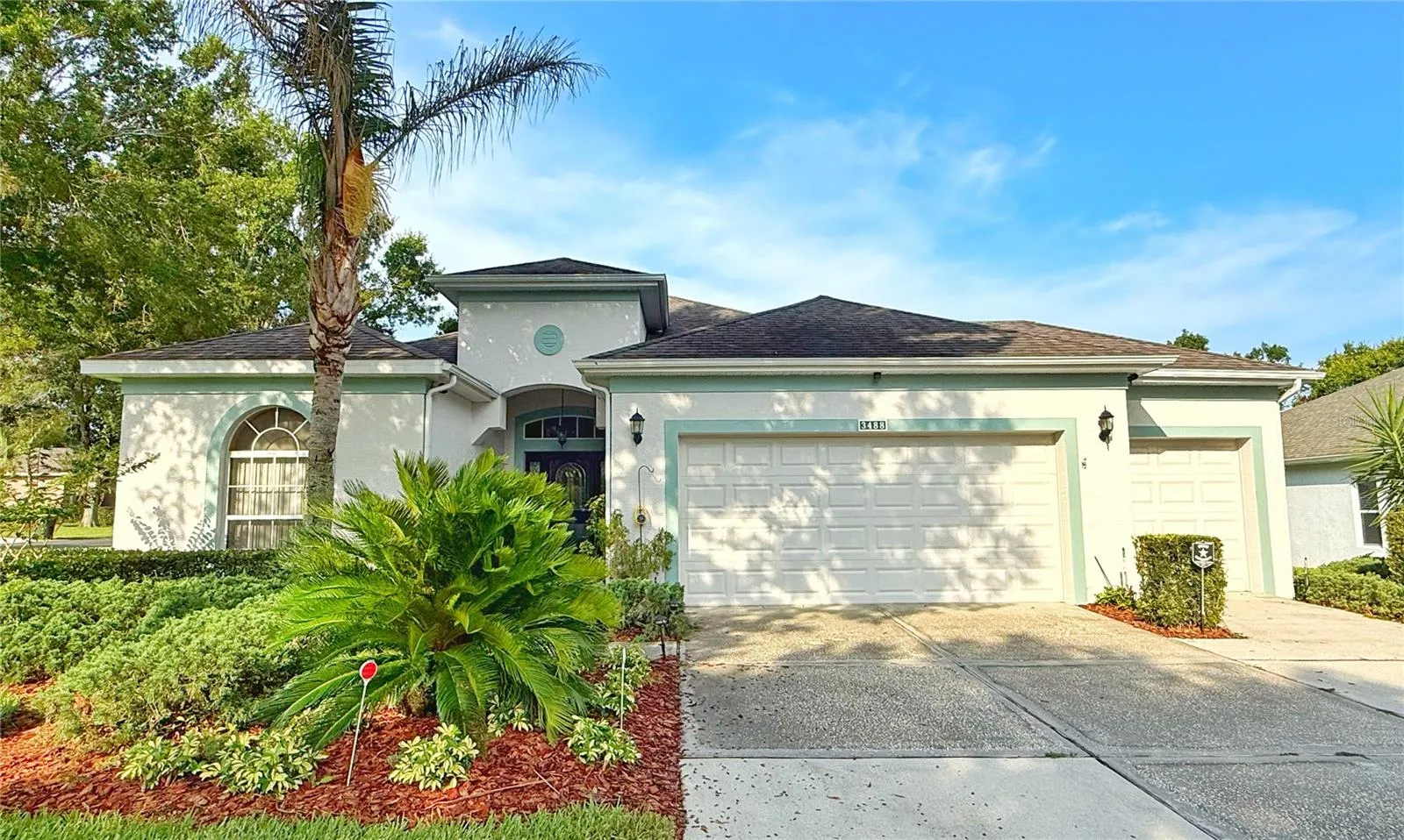 Front exterior w gutters, corner lot, flat, golf cart garage, front entry with glass storm door