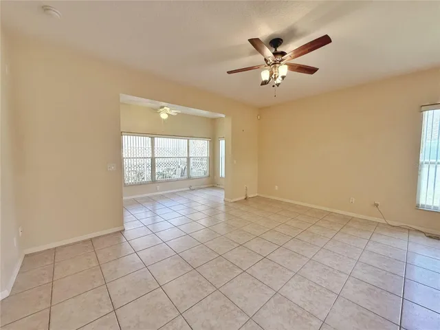 Family room with view of the Florida room that open to the screened in lanai, ceramic tile flooring