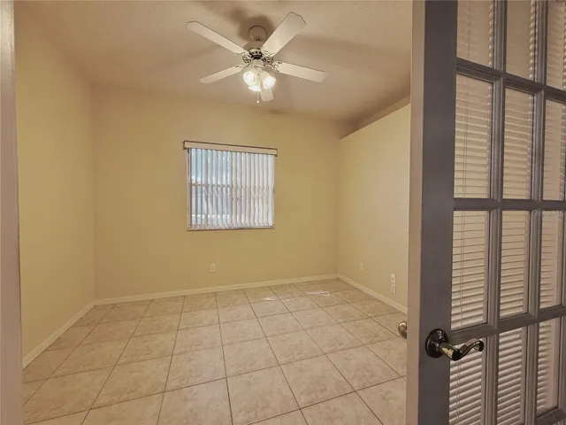 Den/Stidy/Bedroom3 with decorative shelf, double French door entry, ceramic tile flooring