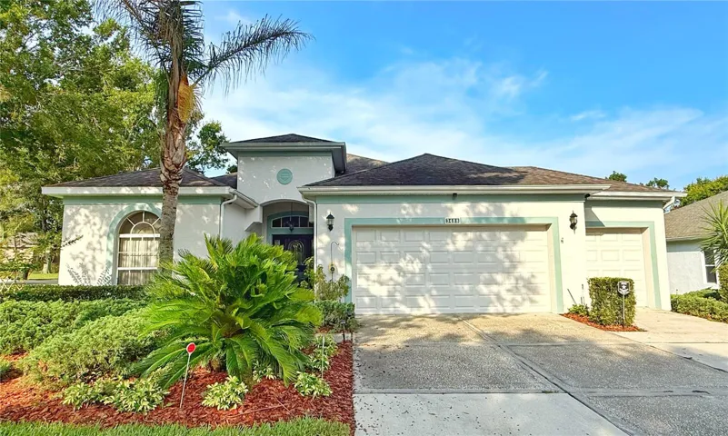 Front exterior w gutters, corner lot, flat, golf cart garage, front entry with glass storm door