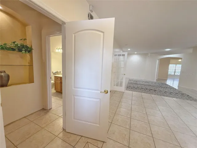 View from Entry of door leading to Bedroom 2 and Bathroom 2 with Living room and French doors to den/study/bedroom 3
