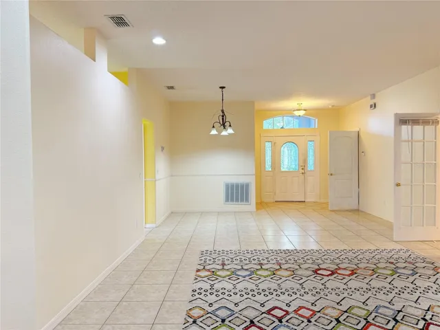 Additional view of the Living room and Dining room, ceramic tile flooring, recessed lighting, light tube,  beveled glass front entry door that also has a glass storm door