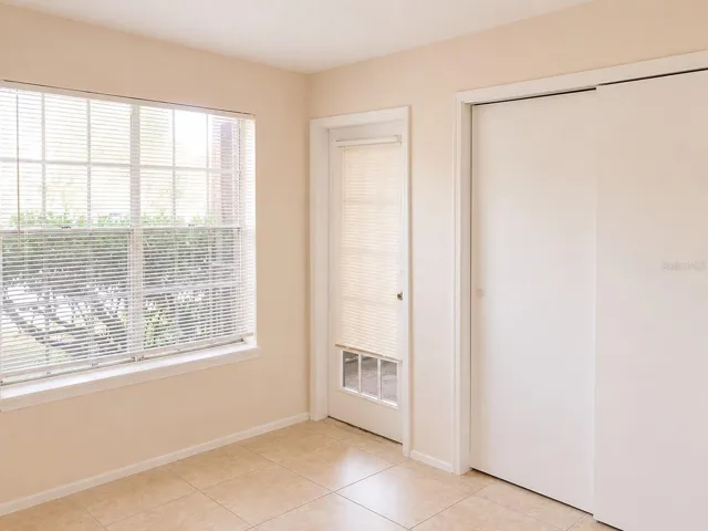 Bedroom #2 with access to screened in patio