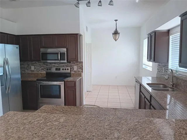 KITCHEN WITH GRANITE COUNTERTOP, BACKSPLASH, STAINLESS STEEL SINK, FAUCET AND APPLIANCES