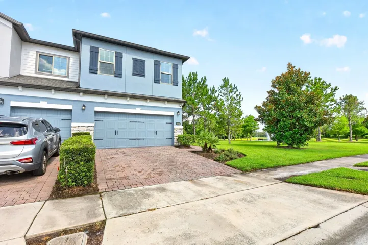 Premium end-unit/corner lot with pond and wooded views.