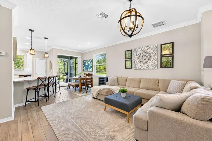 Sliding glass doors open up to the extended screened lanai for ideal indoor/outdoor Florida living.