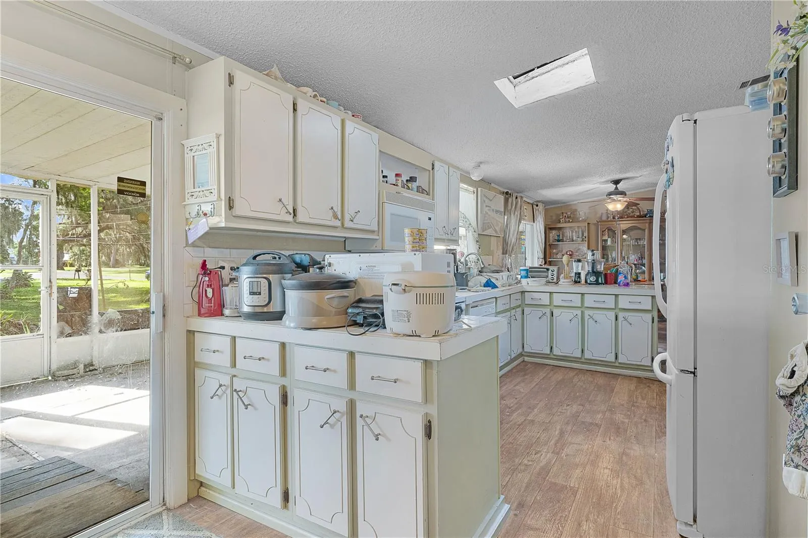 The kitchen boasts plenty of cabinets and counter space