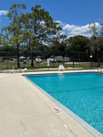 HOA Community Pool with RV/Boat Storage in Background