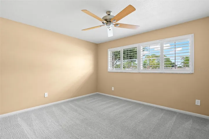 Bedroom 2 - ceiling fan and plantation shutters