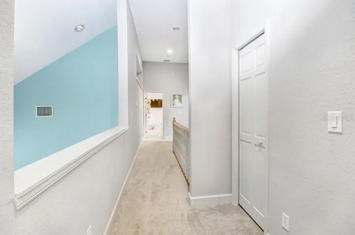 Open view to Great room below and hallway between upstairs bedrooms.