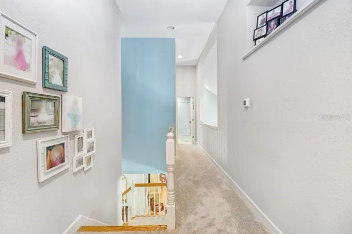 Hallway with pot shelves and open area to the Great Room