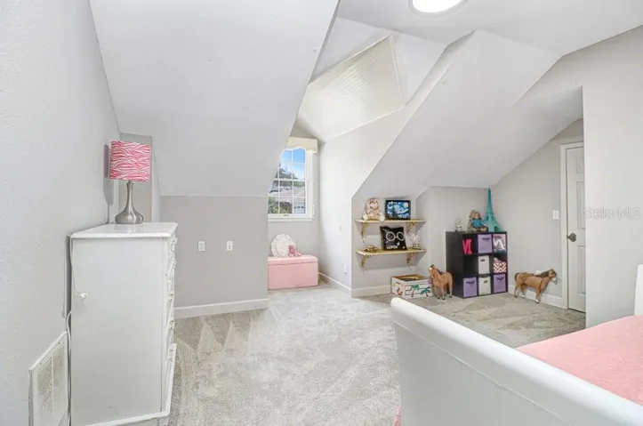 Another oversized bedroom with dormer window area and walk-in closet.