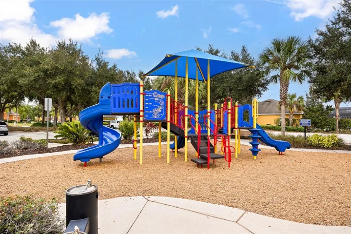 Community playground featuring shaded play equipment, slides, climbing structures, and landscaped surroundings, providing a fun outdoor space for owners and guests of all ages.