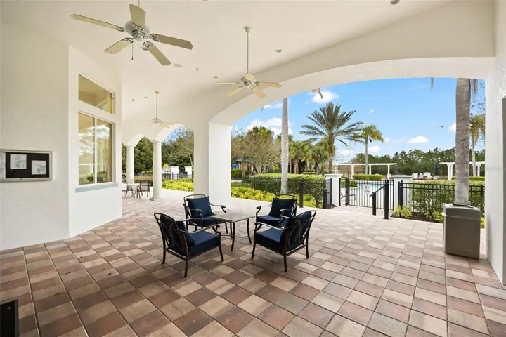 Watersong Resort clubhouse featuring covered outdoor seating overlooking the resort-style swimming pool.