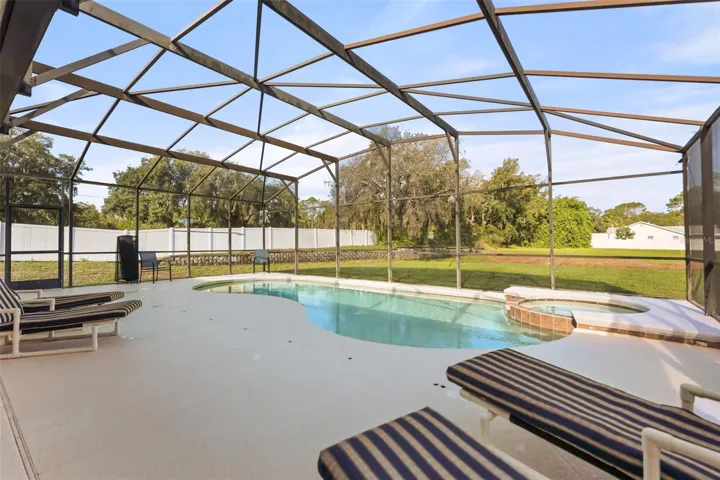 Expansive screened pool enclosure offering ample space to relax, entertain, and enjoy Florida's outdoor lifestyle.