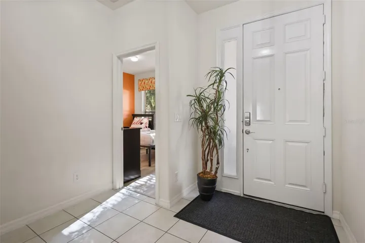 Welcoming entry area with high ceilings, abundant natural light, and convenient access to the guest wing.