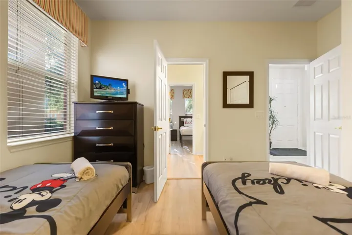 Alternate view of the guest bedroom showcasing comfortable accommodations and ample storage space.