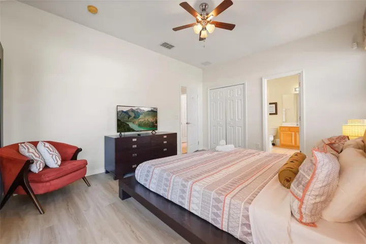 Alternate view of the primary suite showcasing the generous layout and private en-suite bathroom.