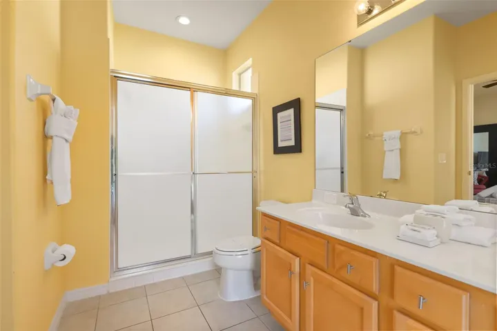 Spacious primary bathroom with a walk-in shower, large vanity, and plenty of natural light.