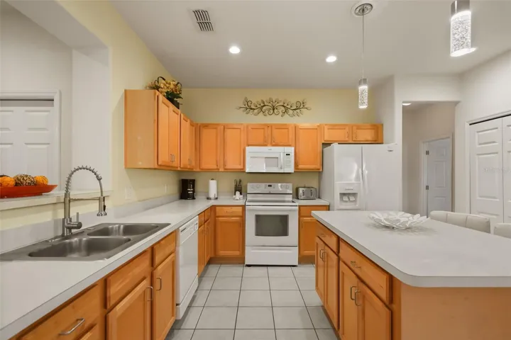 Well-equipped kitchen with abundant storage, white appliances, and an efficient layout for everyday living or vacation rentals.