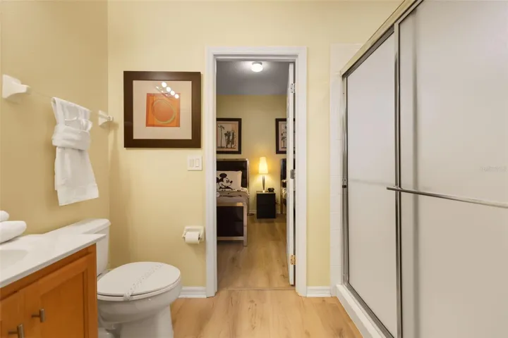 Jack-and-Jill bathroom featuring a large vanity and walk-in shower, conveniently serving the adjoining bedrooms.