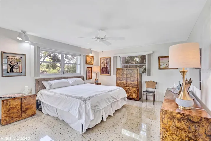 Virtually Staged Primary Bedroom showing Terrazzo Flooring beneath the carpet.